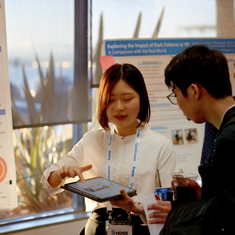 A woman shows a research on the tablet to a man