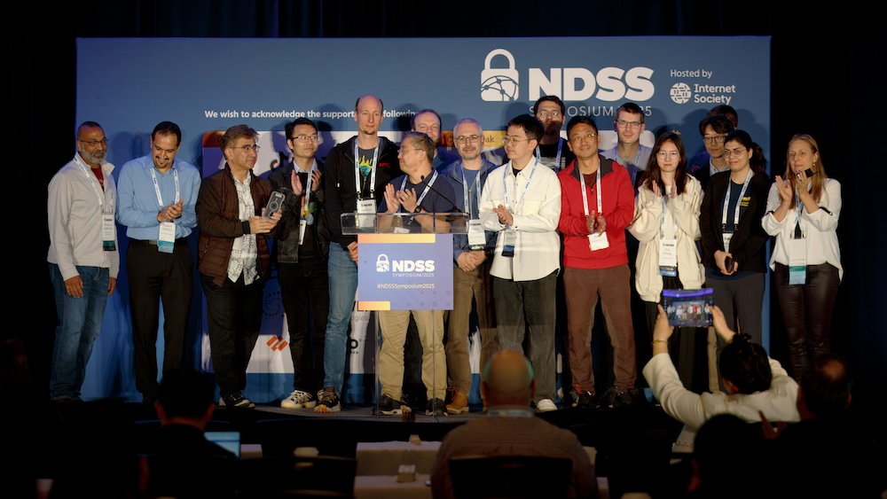 a group of people on the stage applauding